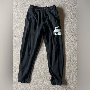 Nike Black Joggers with White Swoosh Graphics